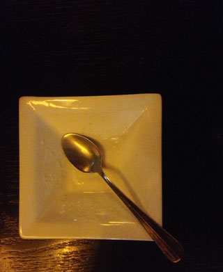 After the fancy dessert is eaten, the tiny plate is empty.