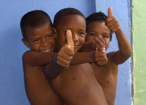 three young boys showing thumbs up