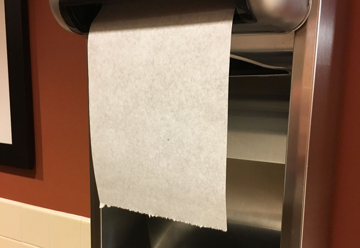 paper towel hanging from an automatic dispenser