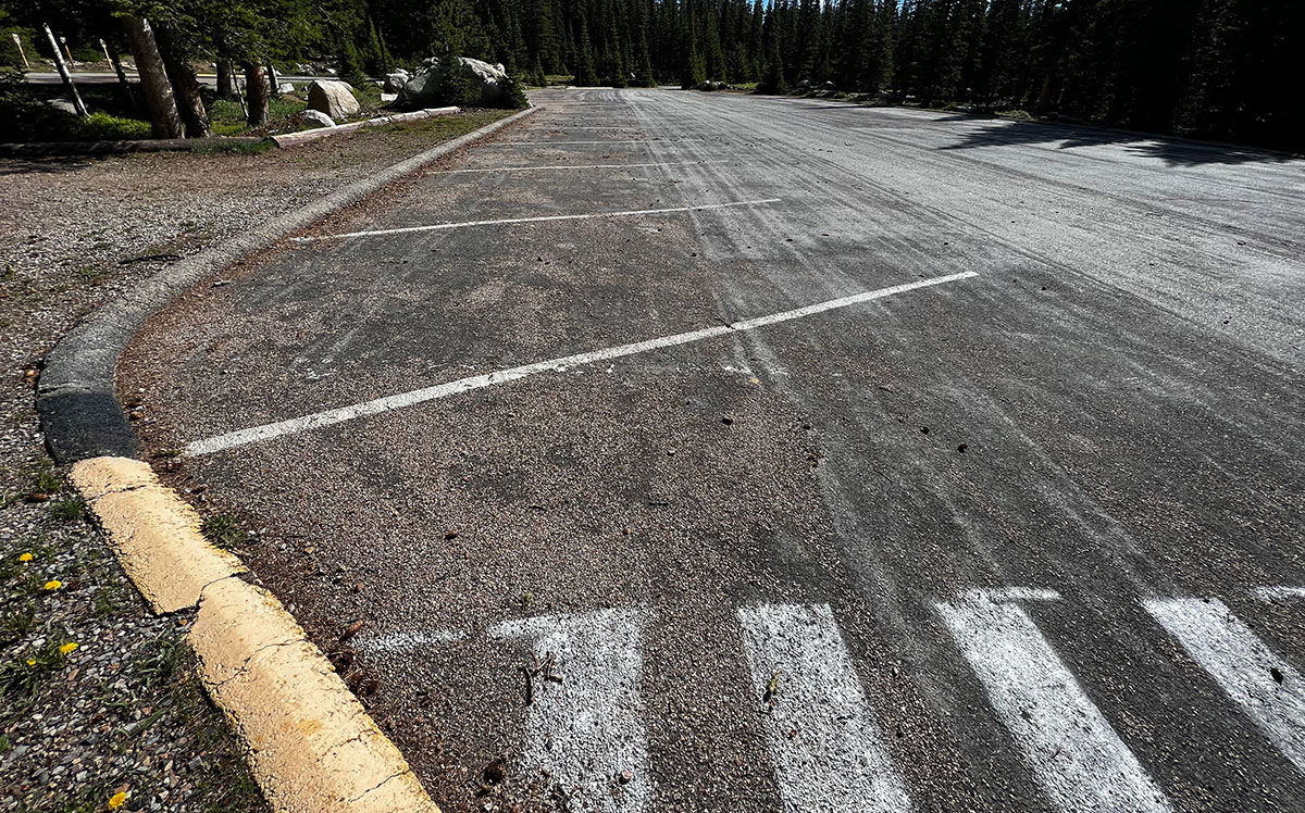 an empty parking lot in a us forest service park